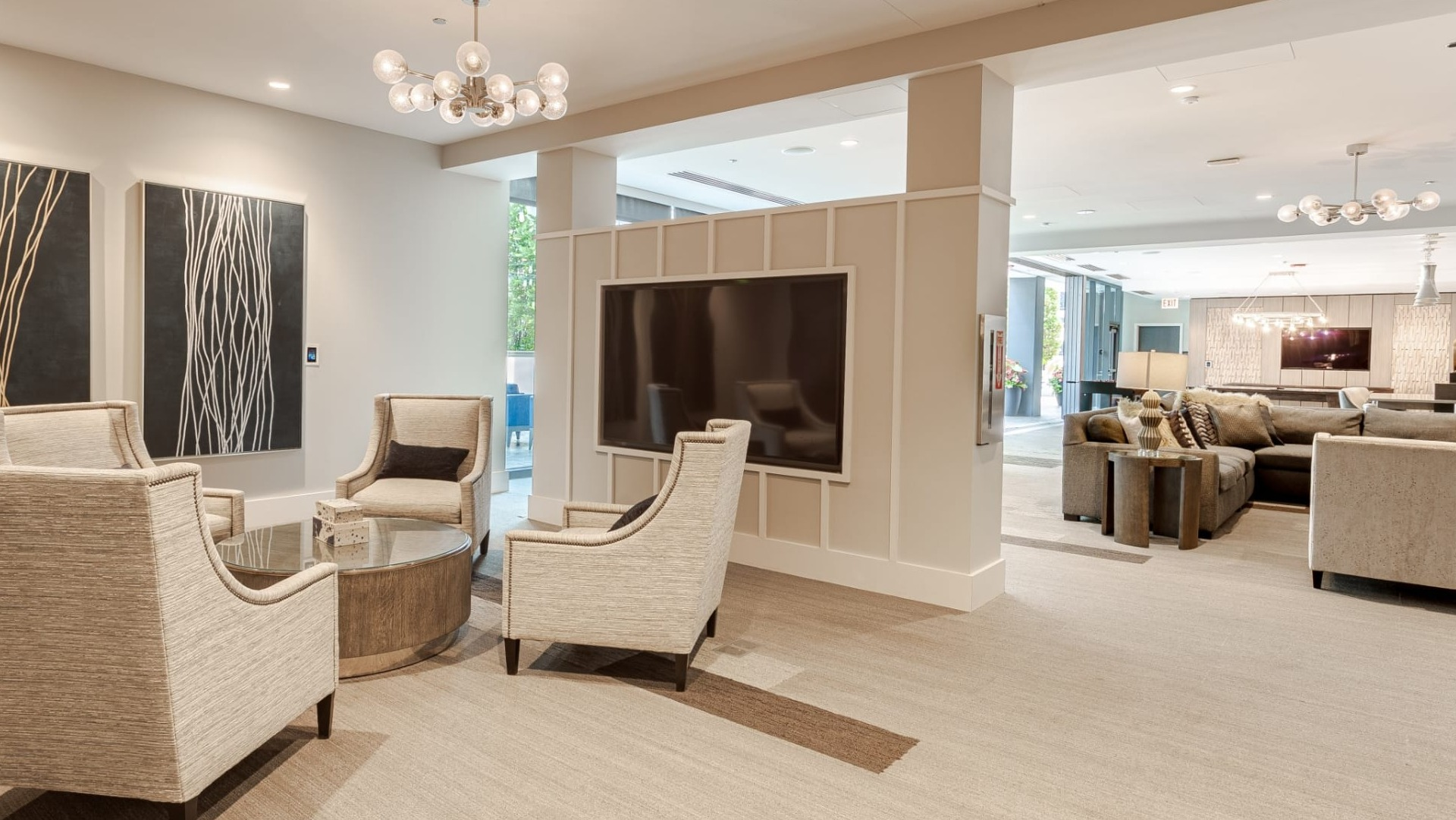 Sophisticated media lounge at The Grand Central Apartments in Chicago, featuring comfortable chairs and a large screen for entertainment