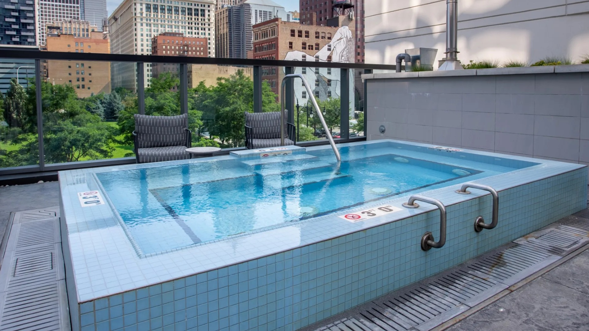 Luxurious outdoor hot tub at The Grand Central Apartments in Chicago, offering city views and a relaxing atmosphere