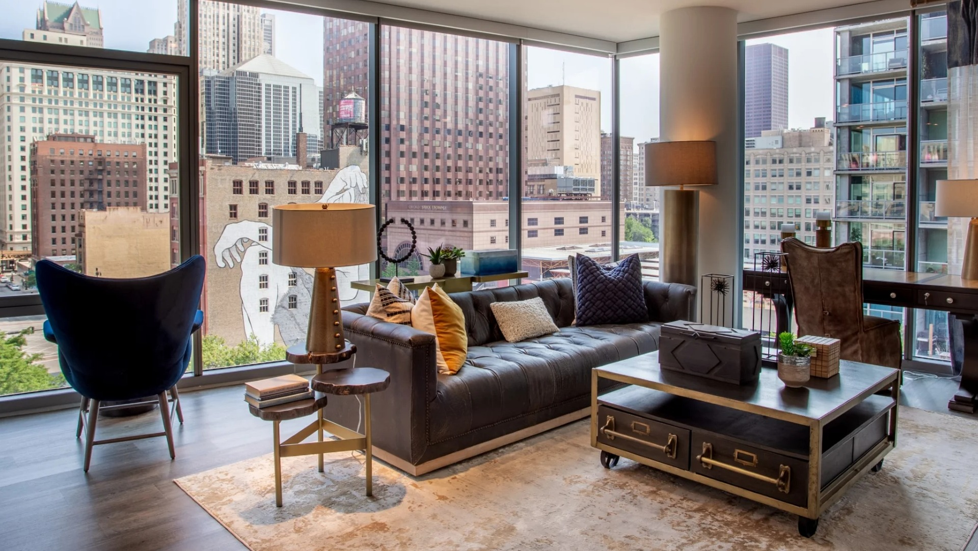 Spacious apartment living room at The Grand Central Apartments in Chicago, featuring a large sofa, elegant decor, and panoramic city views