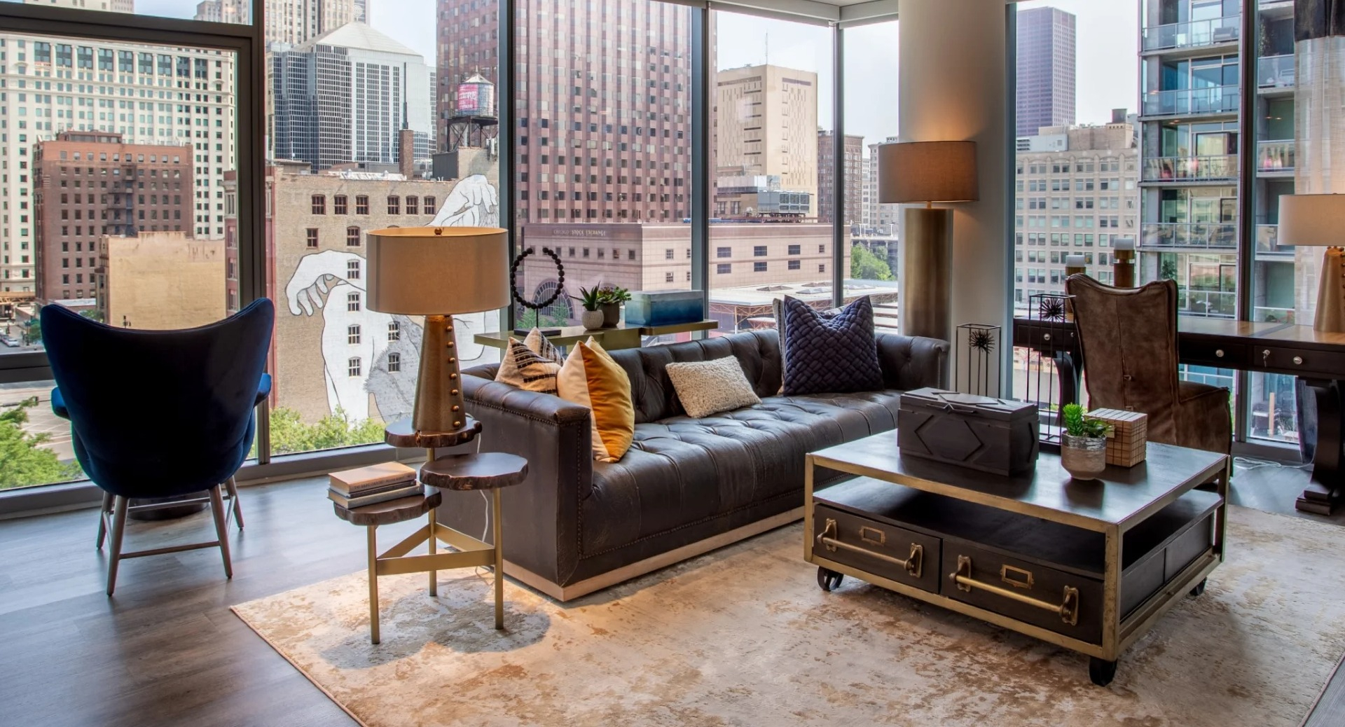 Spacious apartment living room at The Grand Central Apartments in Chicago, featuring a large sofa, elegant decor, and panoramic city views