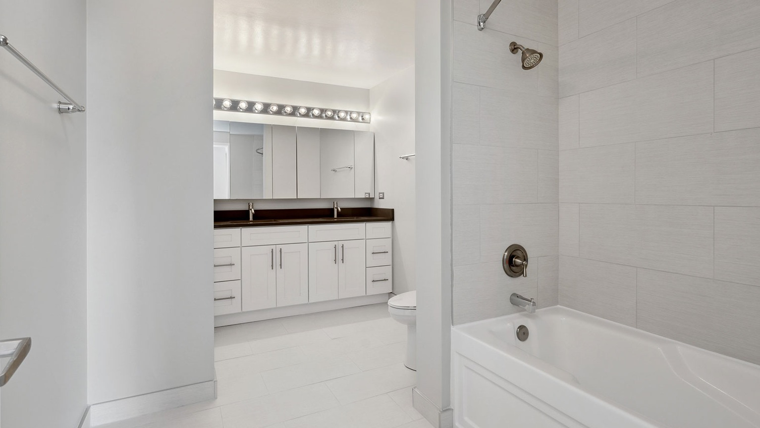 Luxurious bathroom with a double vanity, ample storage, and a large soaking tub at Grand Plaza apartments in Chicago