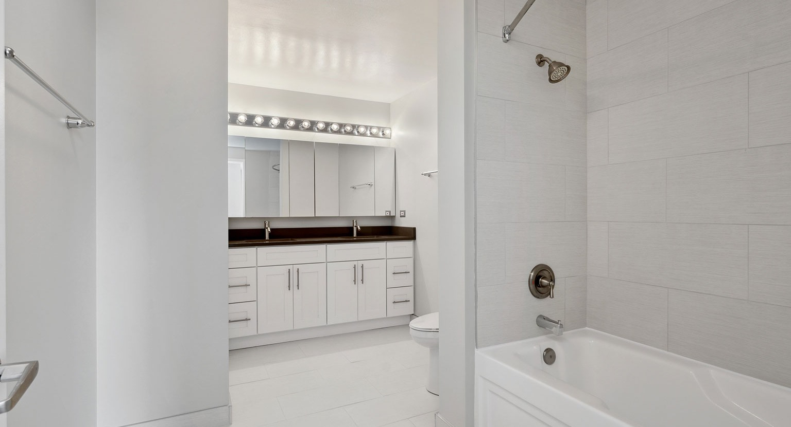 Luxurious bathroom with a double vanity, ample storage, and a large soaking tub at Grand Plaza apartments in Chicago