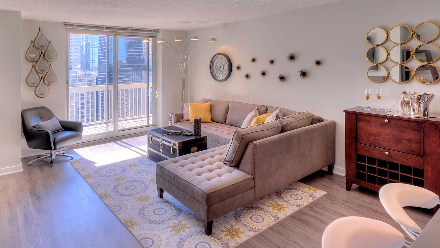 Inviting living room with a comfortable sectional, stylish decor, and direct access to a private balcony at Grand Plaza, Chicago