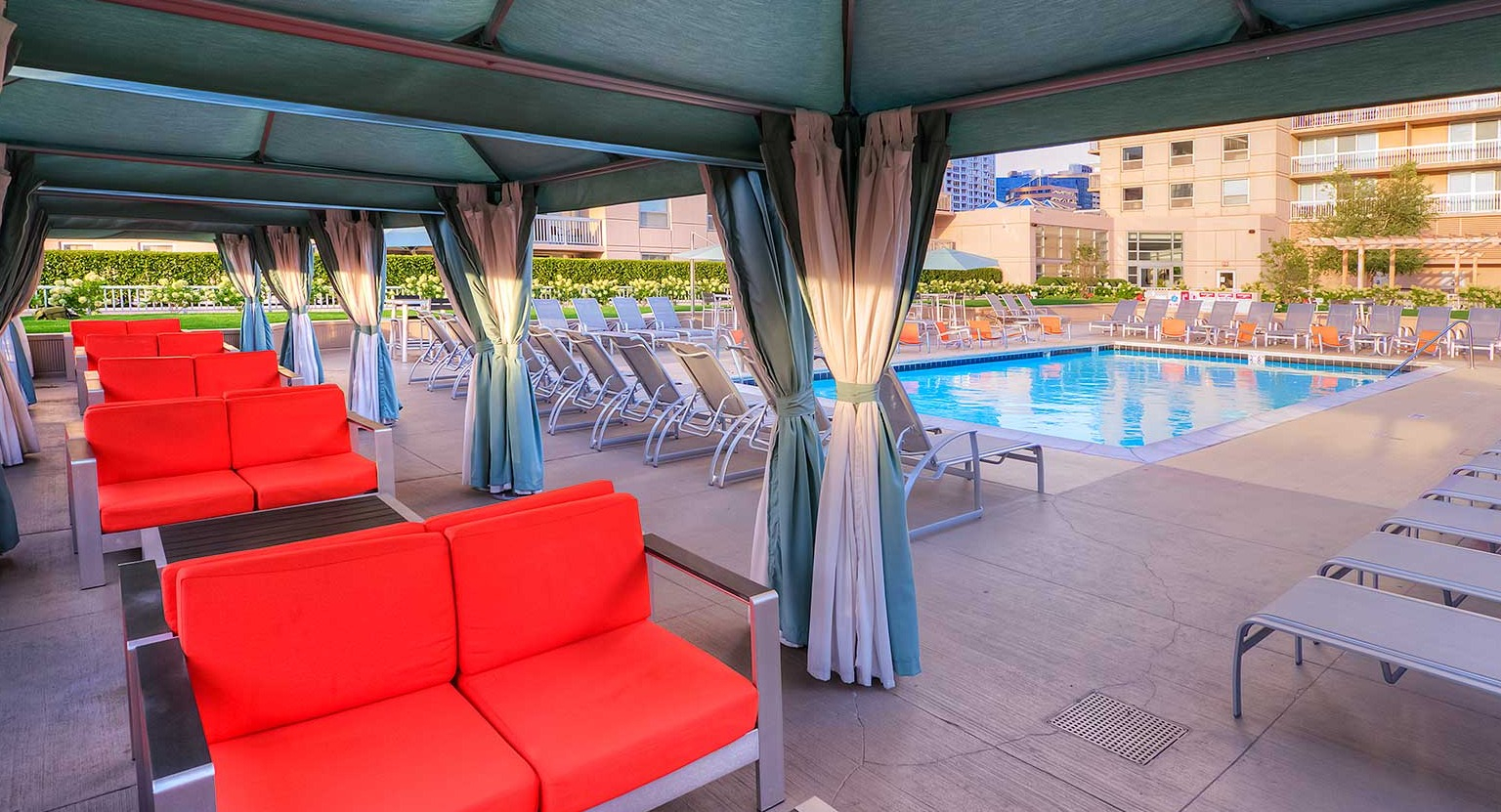 Inviting poolside area with shaded cabanas and comfortable lounge seating, perfect for relaxation at Grand Plaza in Chicago
