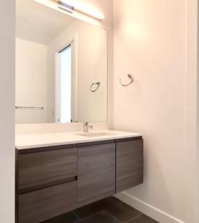 Modern bathroom with a stylish mirror and clean finishes at Hubbard 221 apartments in Chicago