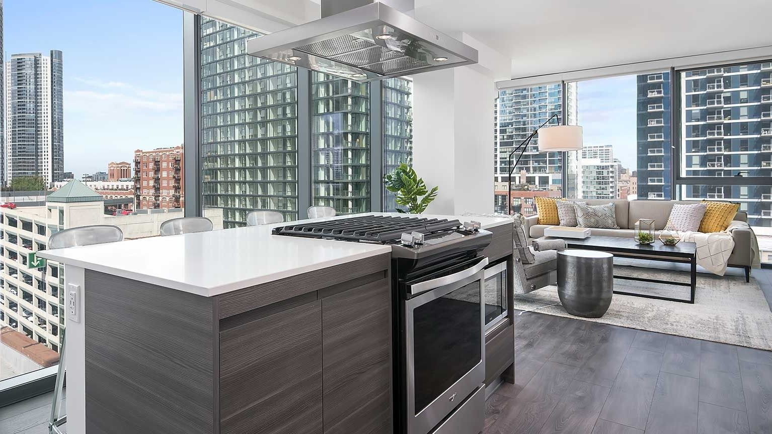 A gourmet kitchen at Hubbard 221 with a large island, stainless steel appliances, and an open layout to the living area