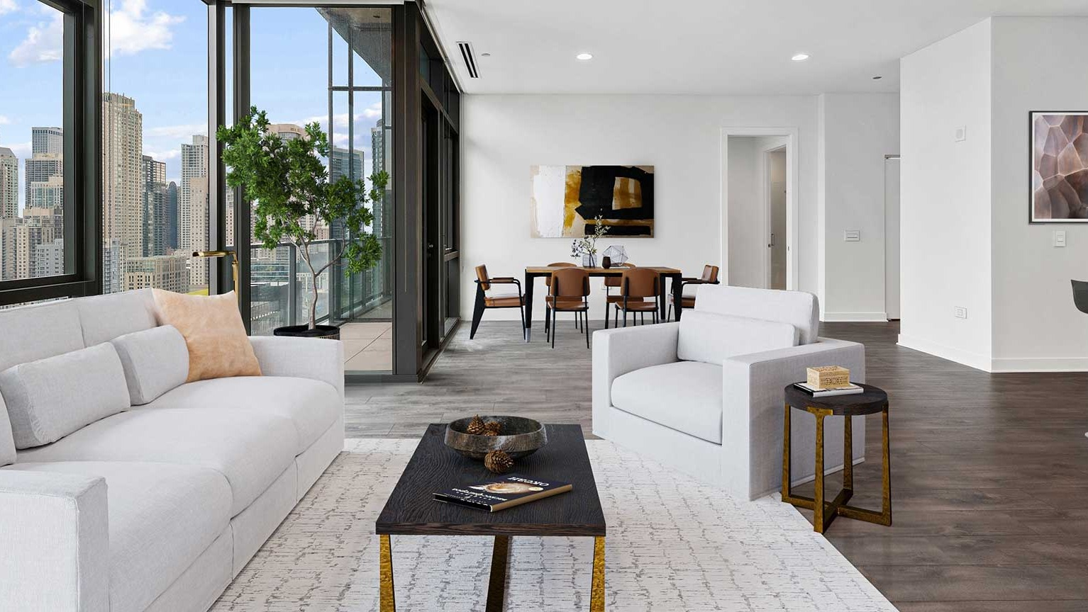 An expansive living and dining area at Hubbard 221 with modern white furniture and stunning skyline views from the balcony