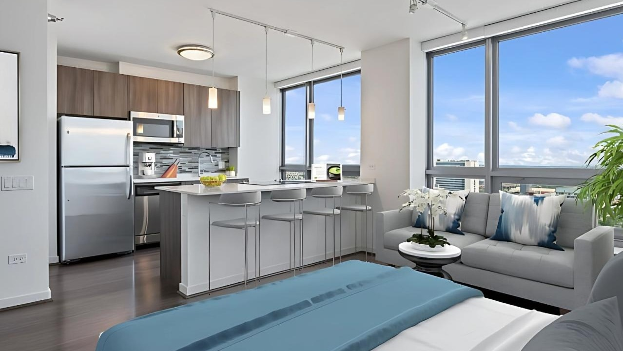 Modern studio apartment featuring an open kitchen with an island, a comfortable living area, and city views at Hubbard Place in Chicago
