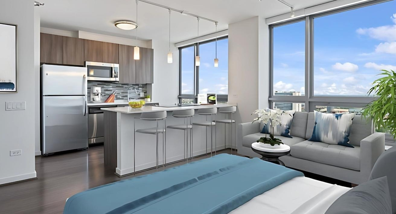 Modern studio apartment featuring an open kitchen with an island, a comfortable living area, and city views at Hubbard Place in Chicago