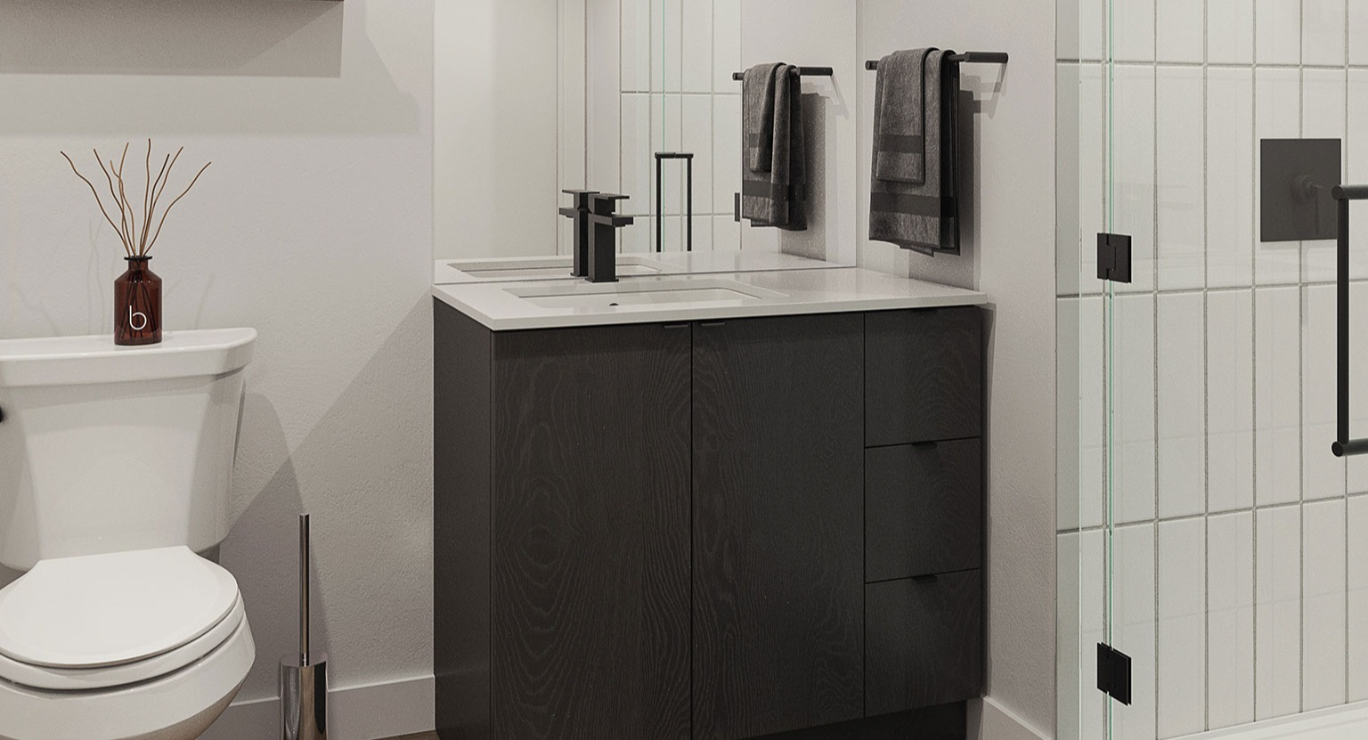 Contemporary bathroom with a modern vanity, toilet, and a sleek walk-in shower with black fixtures at Hugo Apartments River North, Chicago
