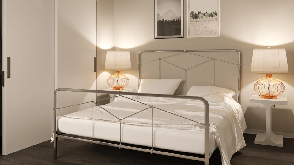 Cozy bedroom with a metal frame bed, modern nightstands, and abstract artwork at Imprint apartments in Chicago