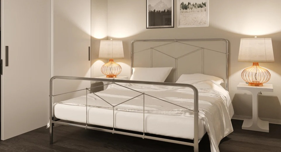 Cozy bedroom with a metal frame bed, modern nightstands, and abstract artwork at Imprint apartments in Chicago