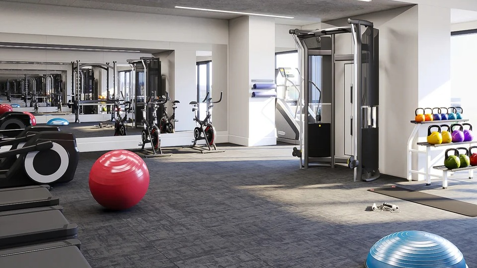 State-of-the-art fitness center with treadmills, weight machines, and free weights, all in a spacious setting at Imprint apartments in Chicago