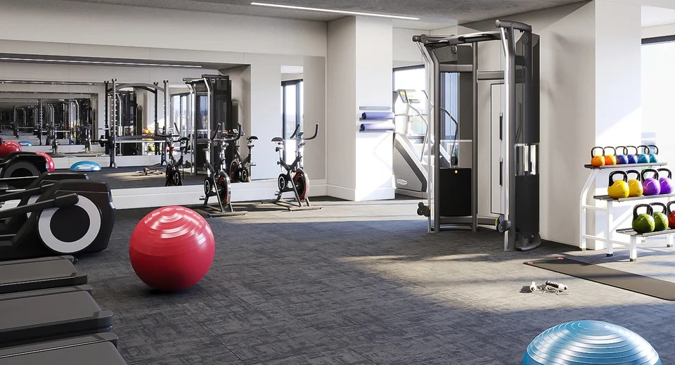 State-of-the-art fitness center with treadmills, weight machines, and free weights, all in a spacious setting at Imprint apartments in Chicago