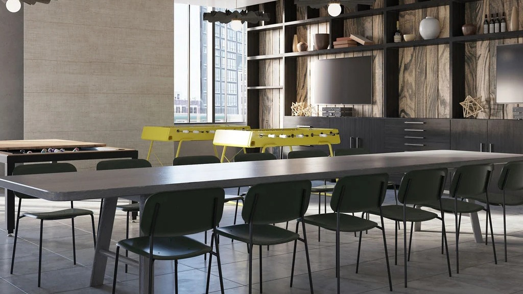 Vibrant game room with shuffleboard, foosball, TVs, and communal tables, perfect for entertainment at Imprint apartments in Chicago