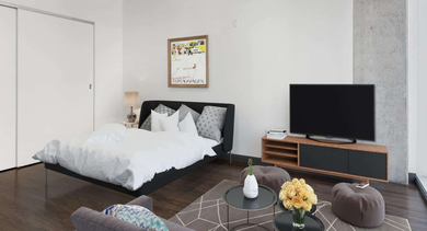 Modern studio apartment showcasing a comfortable bed, a TV console, and a cozy living area at JeffJack Apartments in Chicago