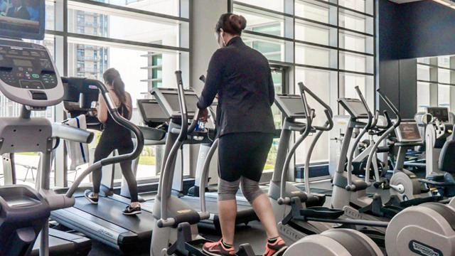 State-of-the-art fitness center with a variety of cardio machines and large windows, perfect for an invigorating workout at K2 Apartments in Chicago