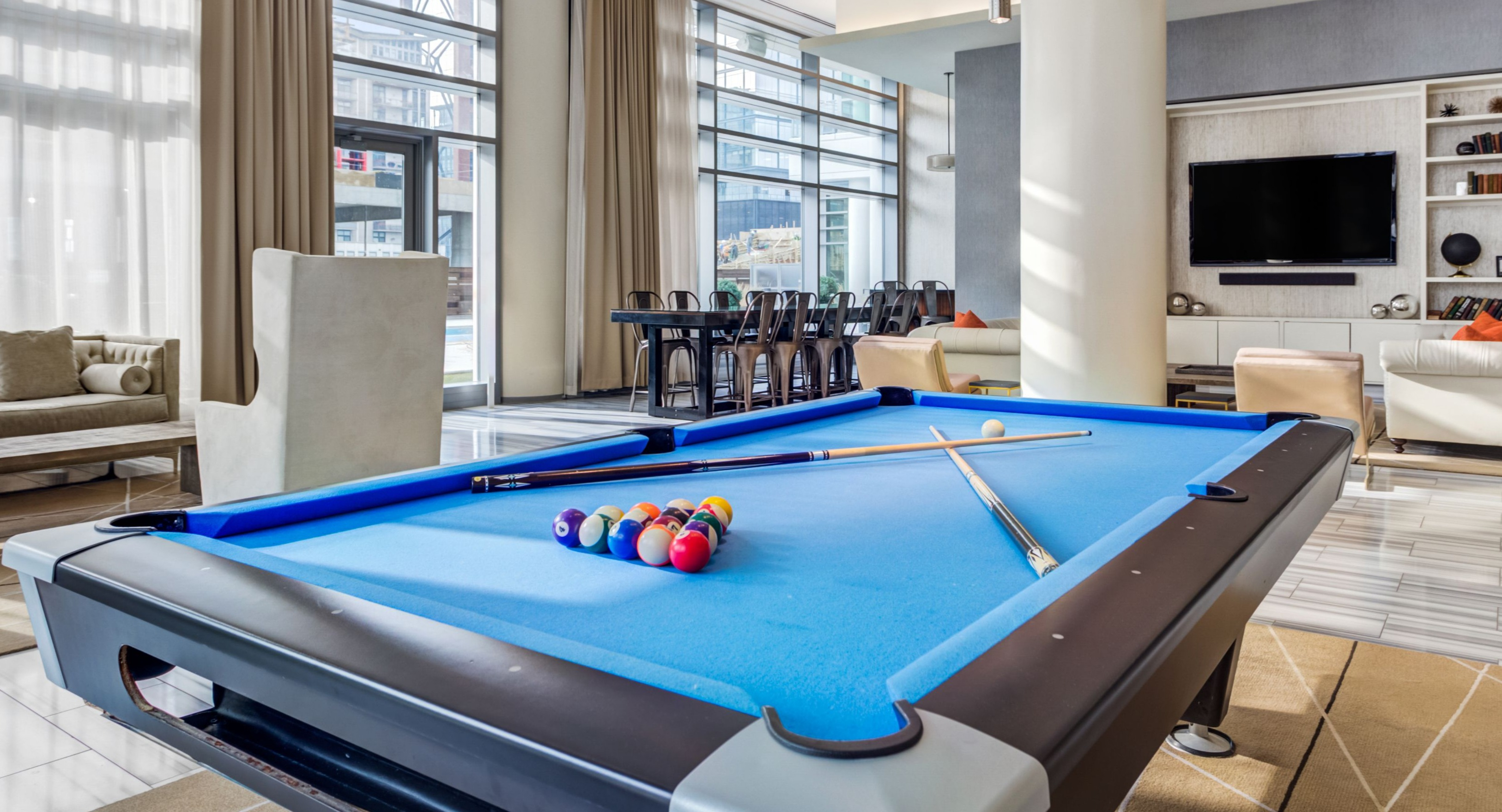 Vibrant game room and resident lounge featuring a billiards table, comfortable seating, and a TV entertainment area at K2 Apartments in Chicago