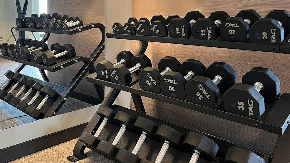 Kingsbury Plaza fitness center offering a comprehensive selection of free weights and workout benches