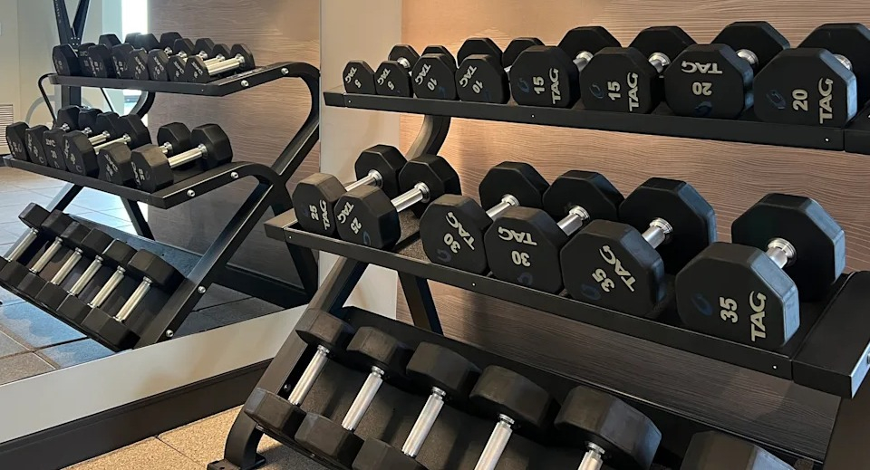 Kingsbury Plaza fitness center offering a comprehensive selection of free weights and workout benches