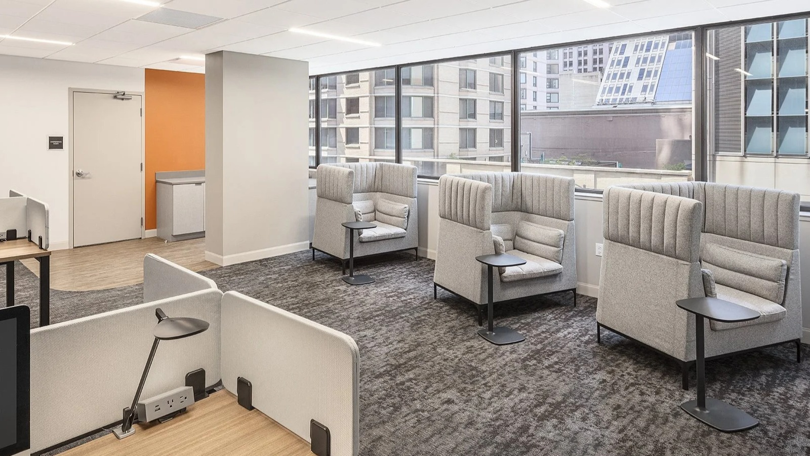 Productive co-working space featuring individual pods and shared desk areas, perfect for residents at Lake Shore Plaza Chicago