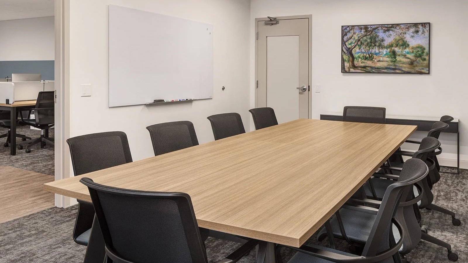 Spacious conference and meeting room with a large table and whiteboard, ideal for group work at Lake Shore Plaza Chicago