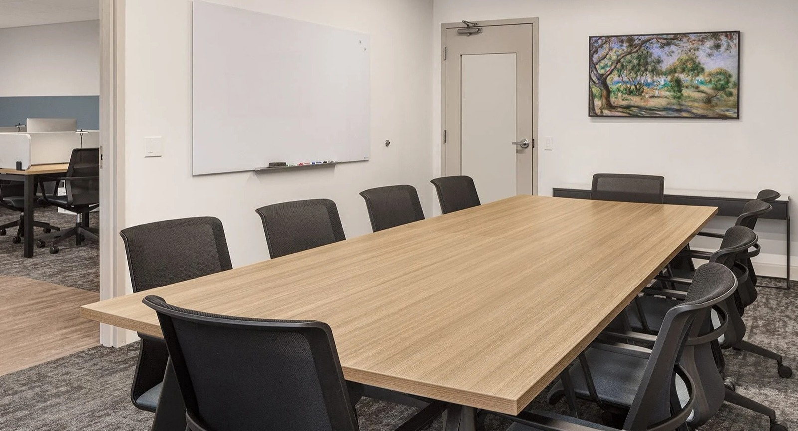 Spacious conference and meeting room with a large table and whiteboard, ideal for group work at Lake Shore Plaza Chicago