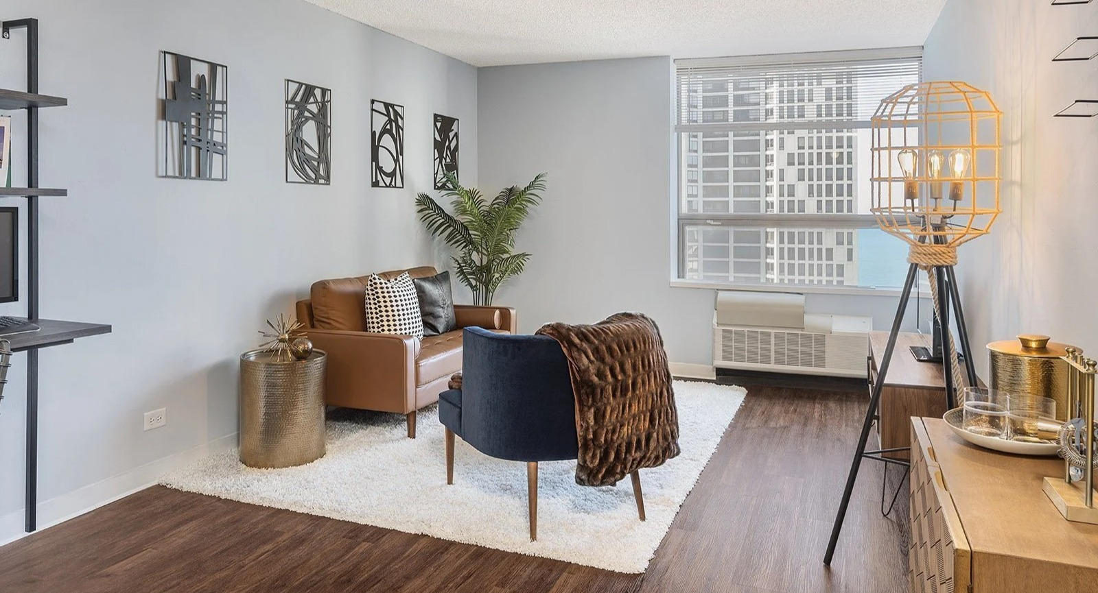 Stylish apartment living room at Lake Shore Plaza in Chicago, featuring modern furniture, unique decor, and large windows with city views