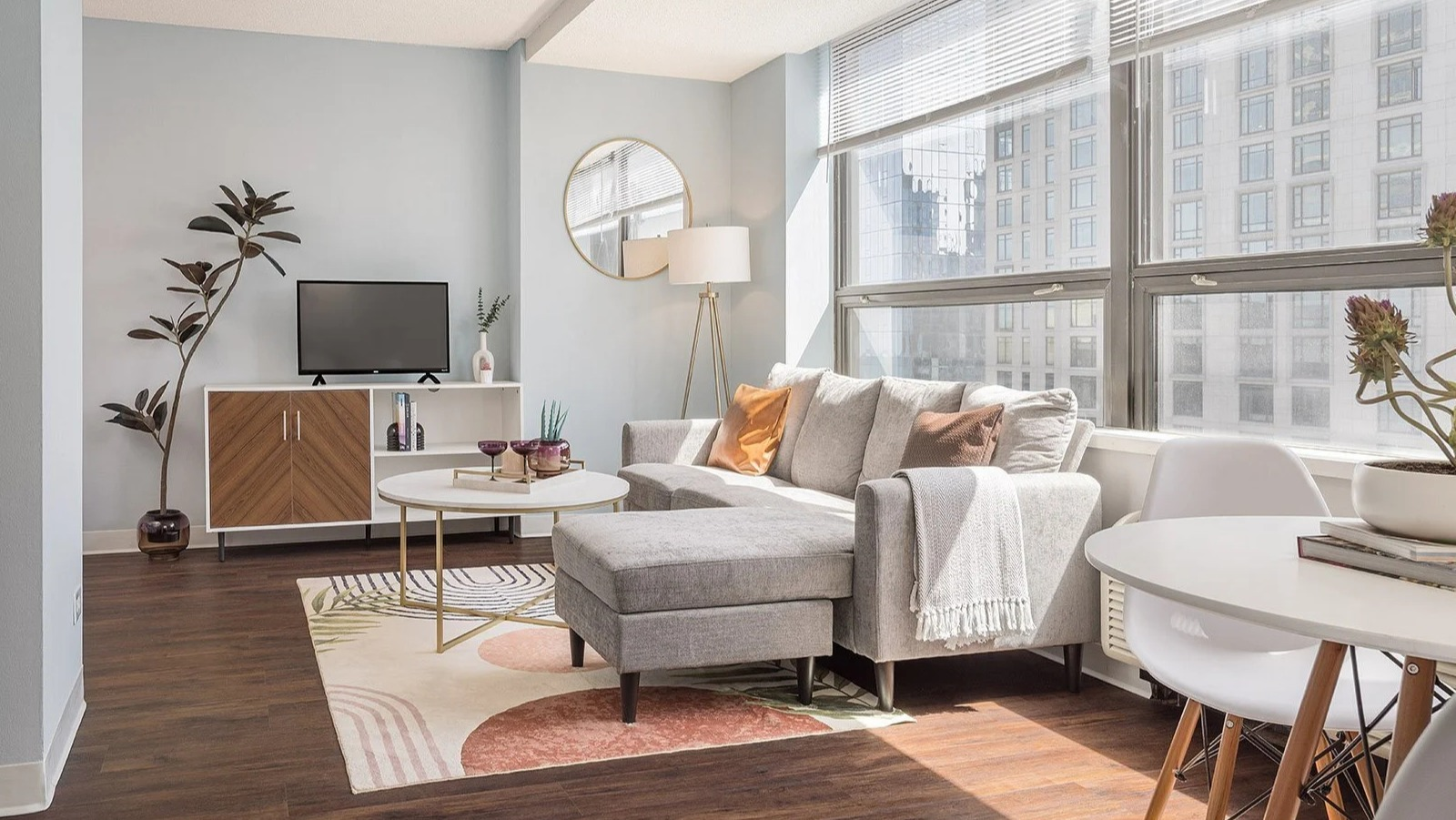 Modern living room with stylish furniture, a comfy sectional, and bright windows at Lake Shore Plaza Chicago