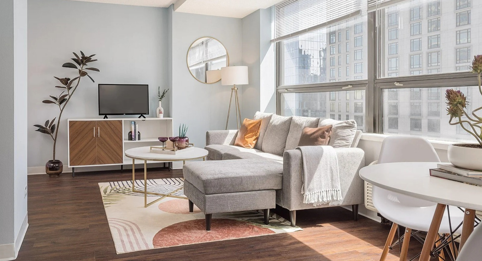 Modern living room with stylish furniture, a comfy sectional, and bright windows at Lake Shore Plaza Chicago