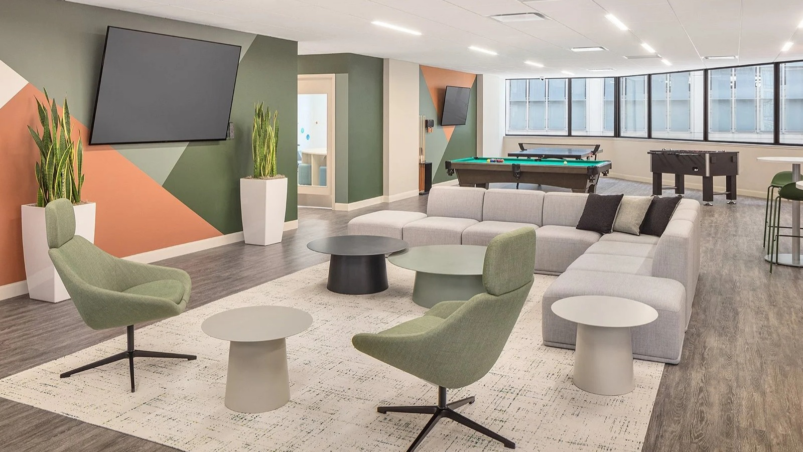 Vibrant resident game lounge with a pool table, shuffleboard, and comfortable seating at Lake Shore Plaza Chicago