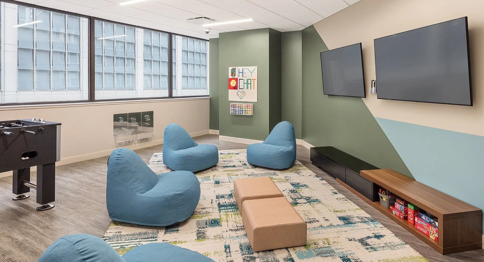 Fun teen game room with foosball, soft seating, and large screen TVs for entertainment at Lake Shore Plaza Chicago