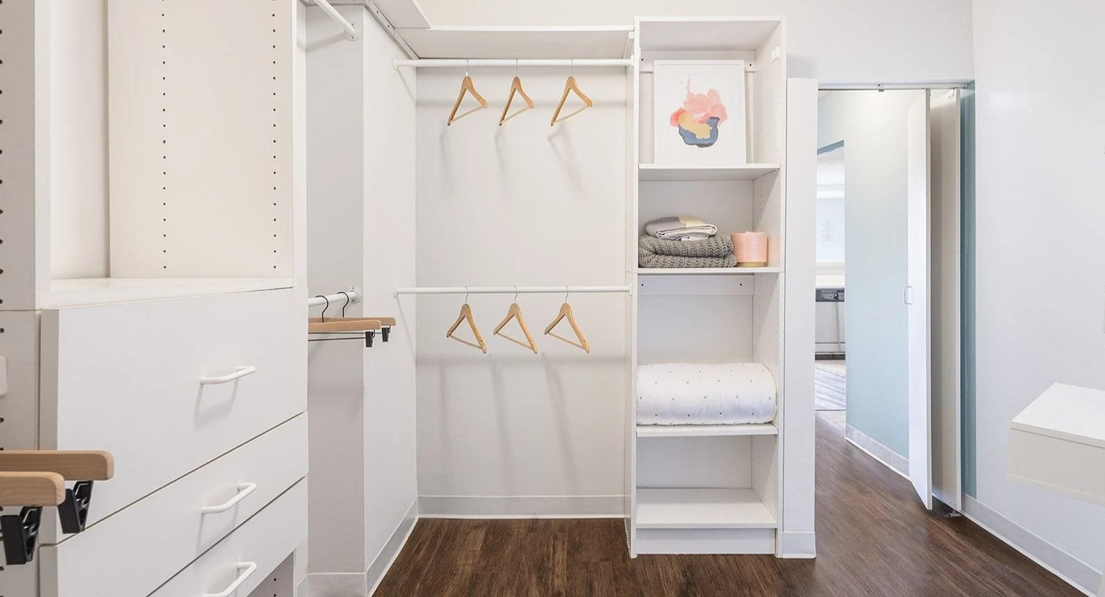 Spacious walk-in closet at Lake Shore Plaza in Chicago, featuring custom shelving and drawers for ample storage
