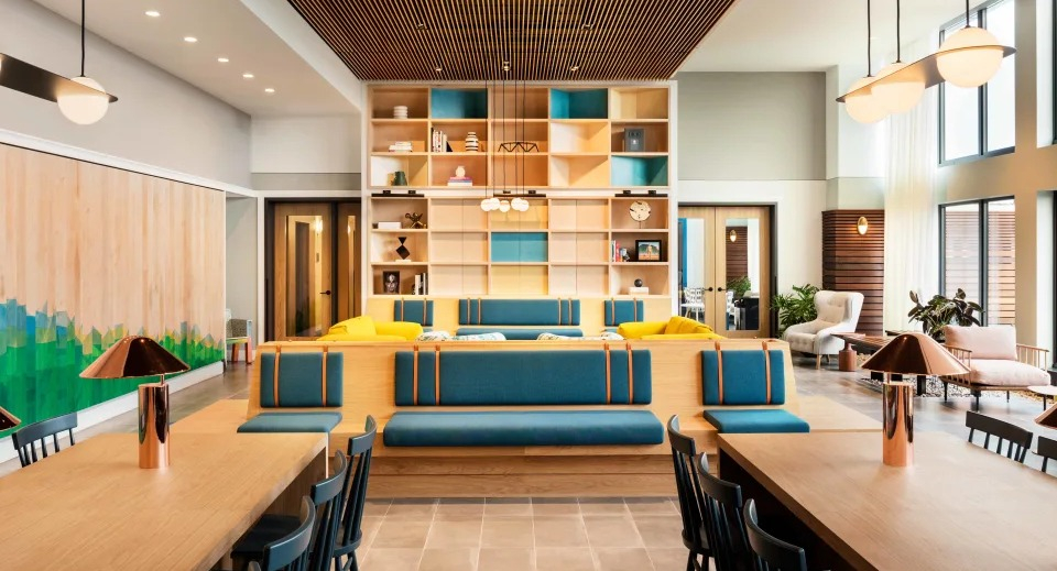Vibrant resident lounge with diverse seating, co-working tables, and a stylish design at Landmark West Loop apartments in Chicago