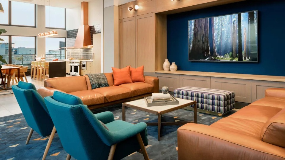Inviting resident lounge or den with modern decor, plush seating, and beautiful lighting at Landmark West Loop apartments in Chicago
