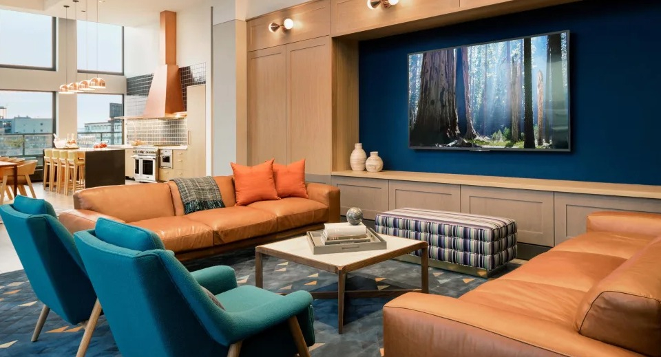 Inviting resident lounge or den with modern decor, plush seating, and beautiful lighting at Landmark West Loop apartments in Chicago