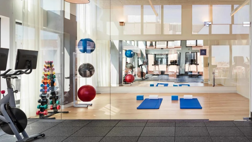 Dedicated yoga and stretching studio with bright natural light and hardwood floors at Landmark West Loop apartments in Chicago