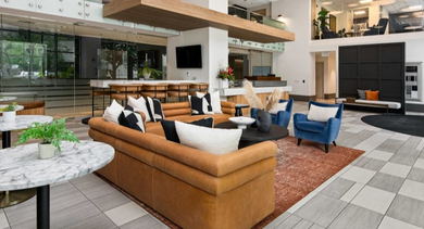 Expansive lobby showcasing multiple seating arrangements and modern architecture, providing welcoming spaces at Left Bank in Chicago