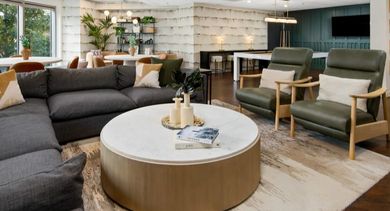 Inviting lounge area with a comfortable sectional, game tables, and diverse seating options for residents at Left Bank in Chicago