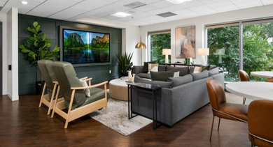 Spacious resident lounge featuring a large TV, comfortable sofas, and ample seating for relaxation at Left Bank apartments, Chicago