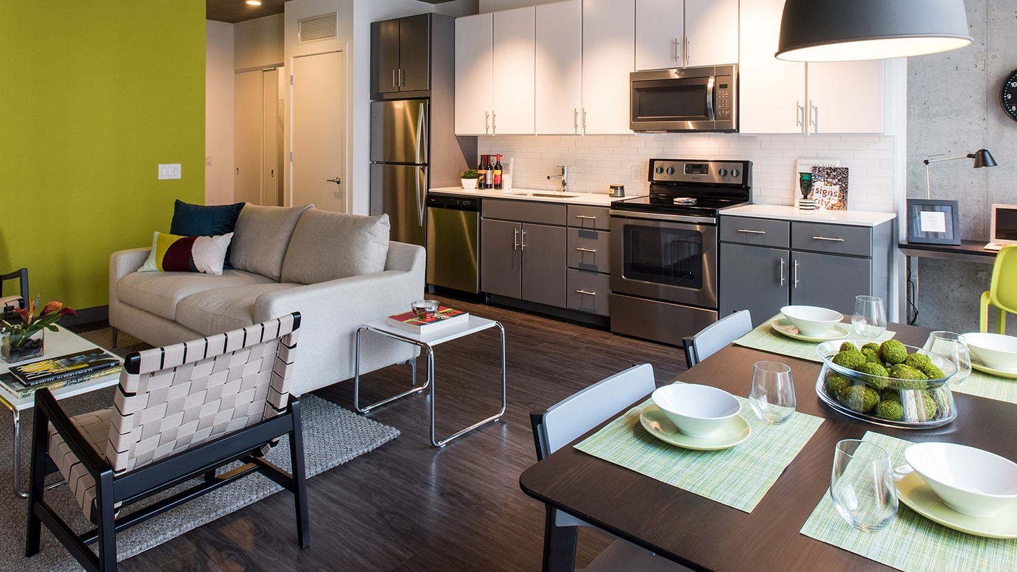 Vibrant open-concept living room and kitchen area with stylish furniture and colorful accents at Linea Apartments in Chicago