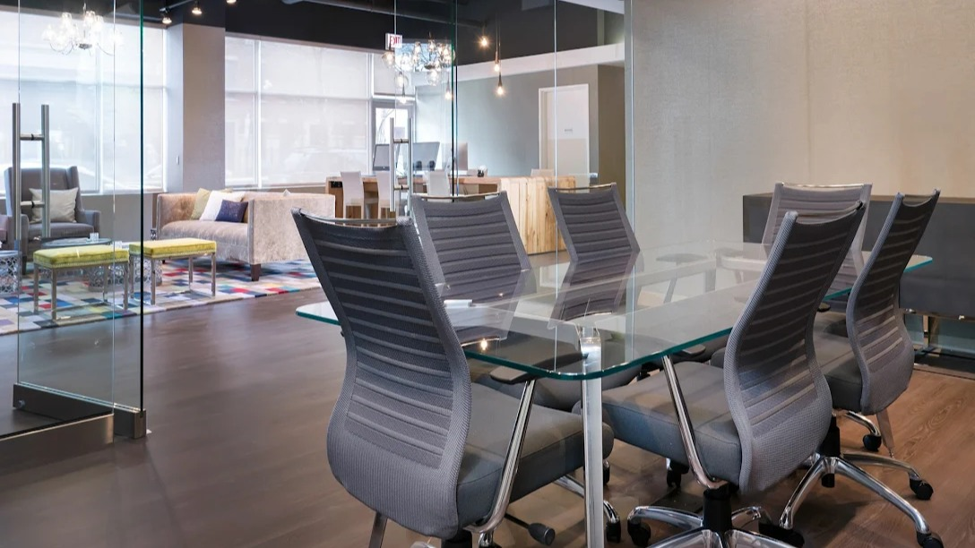 Modern conference room at Luxe on Madison Apartments in Chicago, featuring a glass table and stylish seating