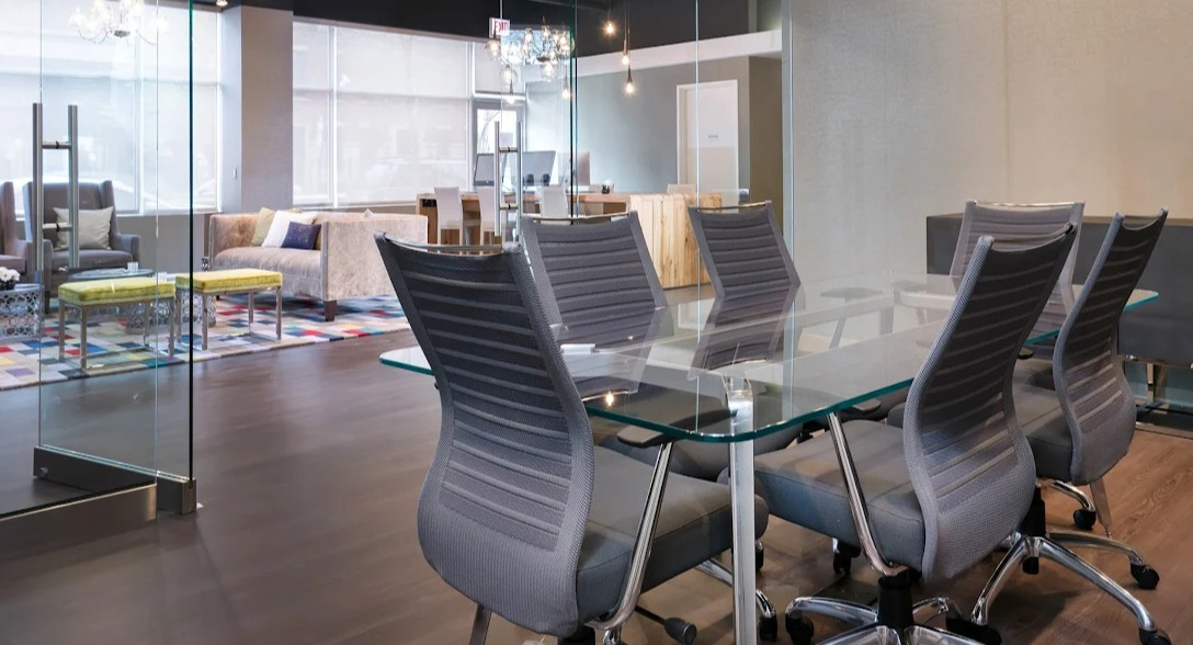 Modern conference room at Luxe on Madison Apartments in Chicago, featuring a glass table and stylish seating