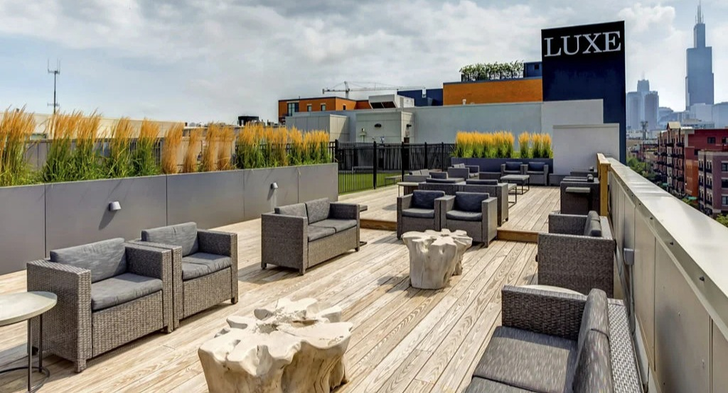 Rooftop lounge at Luxe on Madison Apartments in Chicago with modern outdoor seating and panoramic city skyline views