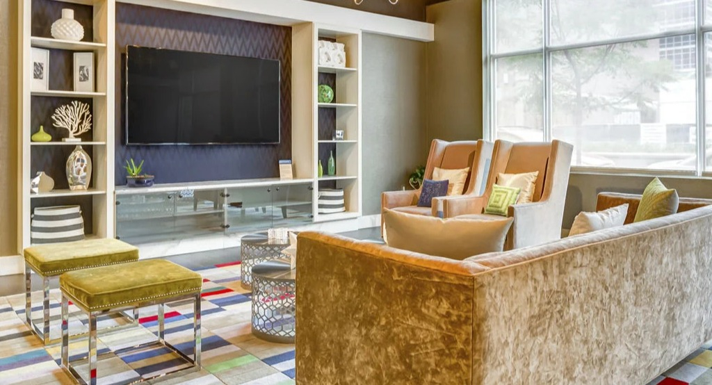 Inviting resident lounge with plush sofas, a large TV, and colorful accents, perfect for relaxation at Luxe on Madison Apartments in Chicago