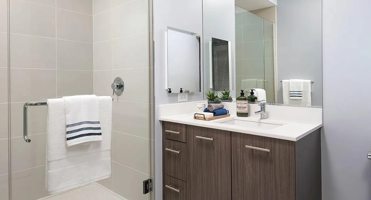 Modern bathroom featuring a spacious walk-in shower with glass enclosure and a stylish vanity at Marquee at Block 37 in Chicago
