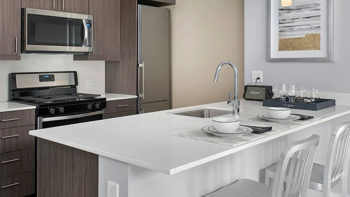 Modern gourmet kitchen with stainless steel appliances, ample cabinet space, and a breakfast bar at Marquee at Block 37 in Chicago