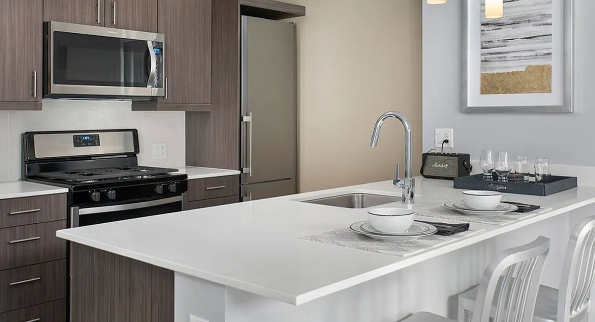 Modern gourmet kitchen with stainless steel appliances, ample cabinet space, and a breakfast bar at Marquee at Block 37 in Chicago