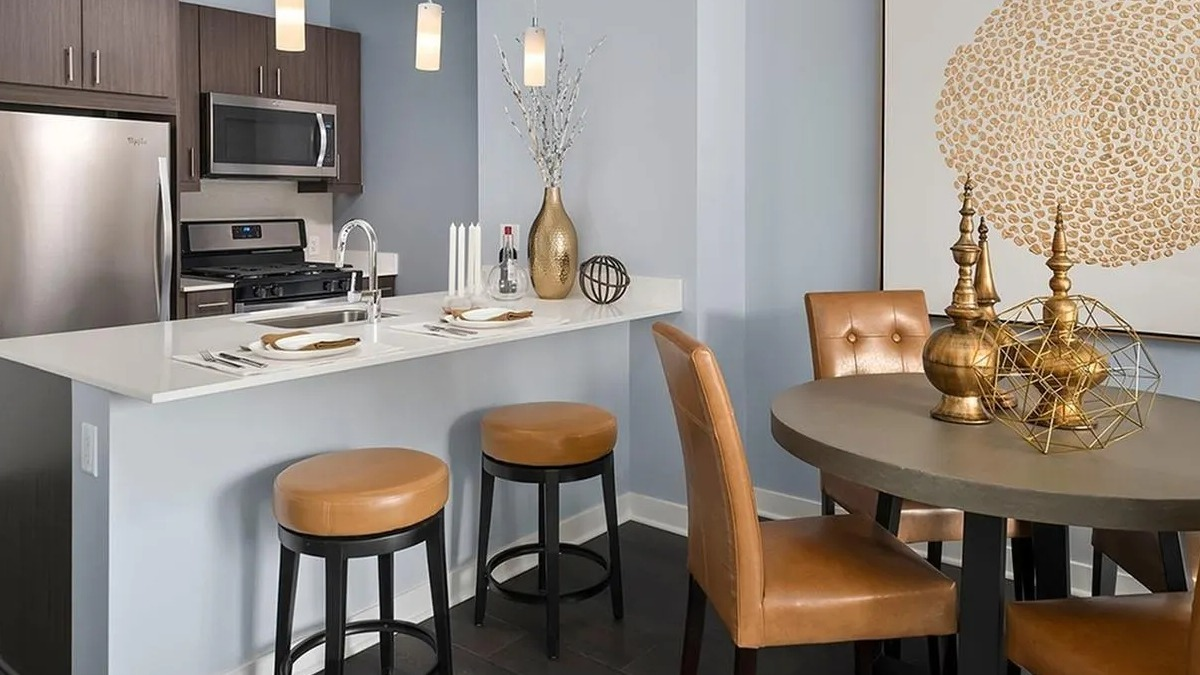 Open concept kitchen with a breakfast bar, stainless steel appliances, and a dining area at Marquee at Block 37 in Chicago