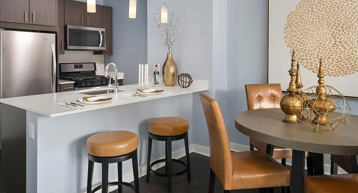 Open concept kitchen with a breakfast bar, stainless steel appliances, and a dining area at Marquee at Block 37 in Chicago